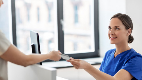 doctor and patient with credit card at hospital
