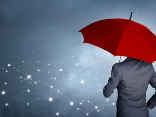 Businessman standing while holding red umbrella over the network