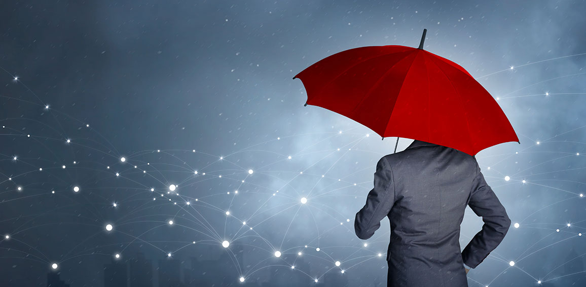 Businessman standing while holding red umbrella over the network