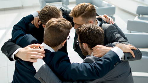 group of business people standing in a close circle.