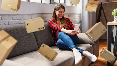 Woman does shopping through e-commerce online shop. Concept of fast delivery