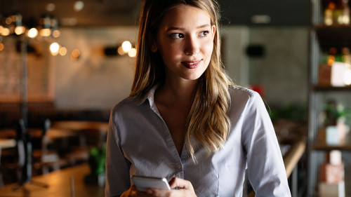 Beautiful brunette coworker businesswoman talking on mobile phone