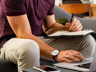 Busy businessman working on laptop at home