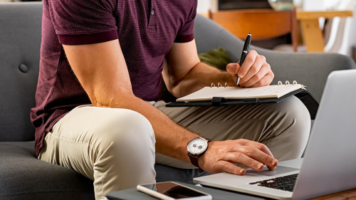 Busy businessman working on laptop at home