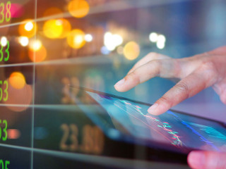 Businessman using tablet at night timeStock market. Businessman