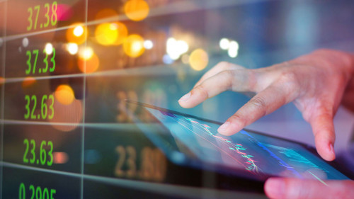 Businessman using tablet at night timeStock market. Businessman