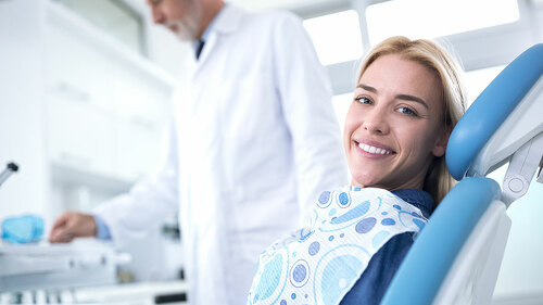 Smiling and happy young woman after successful treatment