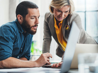 Coworkers team at work. Group of young business people in trendy casual wear working together in creative office