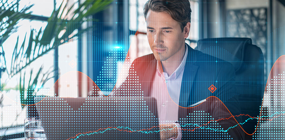 Handsome businessman in suit at workplace working with laptop to optimize trading strategy at corporate finance fund. Forex chart hologram over office background