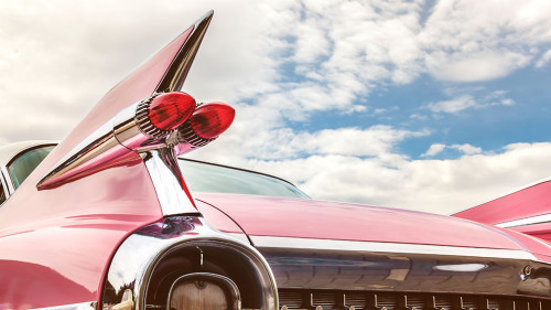 Rear end of a pink classic car