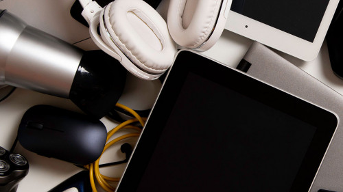 Old computers, digital tablets, mobile phones, many used electronic gadgets devices, broken household and appliances on white background. Planned obsolescence, electronic waste for recycling concept
