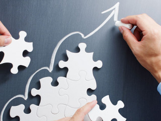 Working on steps shaped jigsaw puzzle. Drawing up arrow on black