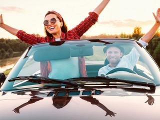 Traveling by car - happy couple in love go by cabriolet car in s