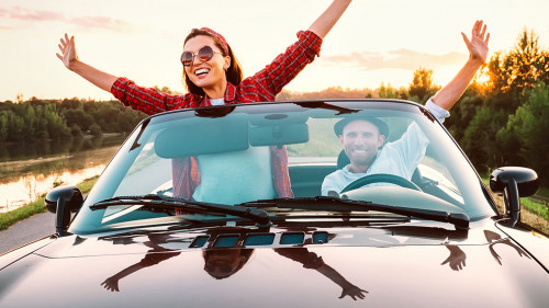 Traveling by car - happy couple in love go by cabriolet car in s