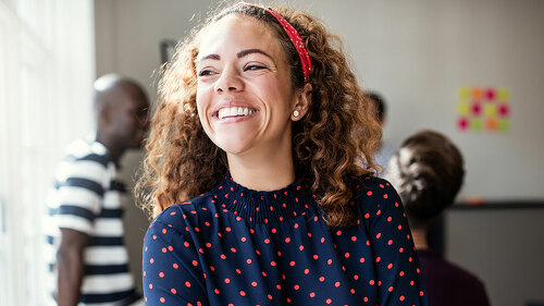 Laughing young designer standing in an office after a meeting