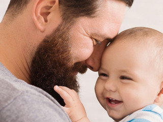 Loving father embracing his cute baby son