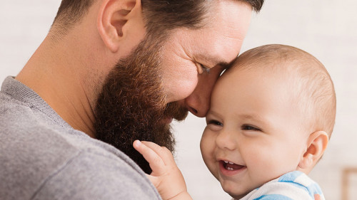 Loving father embracing his cute baby son