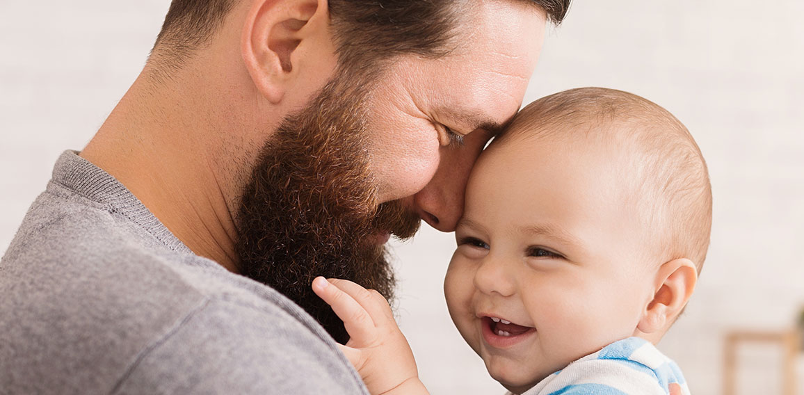 Loving father embracing his cute baby son