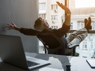 Outgoing old businessman gesticulating hands in office