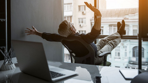 Outgoing old businessman gesticulating hands in office