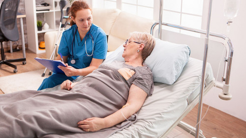 Senior woman lying in nursing home bed