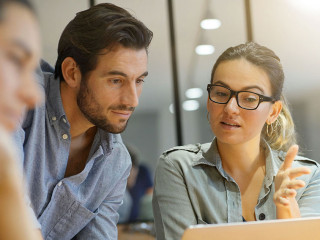 Colleagues workshopping business ideas in modern co working spac