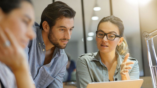 Colleagues workshopping business ideas in modern co working spac