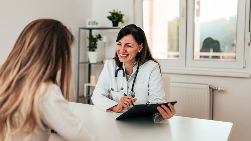 Young doctor and patient talking in the doctor's office.