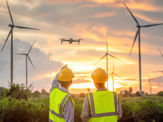two asian engineers male flying drone surveying and checking win