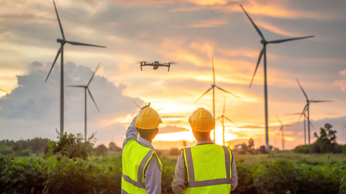 two asian engineers male flying drone surveying and checking win