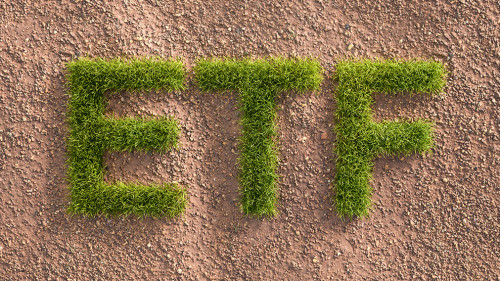 Green grass letters ETF in an arid landscape. Concept for Exchange traded funds investing by ESG standards (environment social governance).