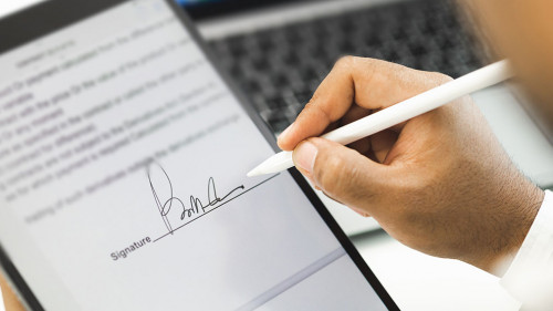 Close up businessman hand electronic Signature on Tablet by Styl