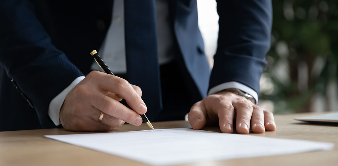 Close up young businessman ready signing profitable offer agreement.