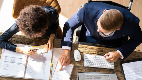 Businesspeople Using Laptop In Office