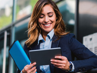 Young businesswoman working with tablet outdoor. Business, educa