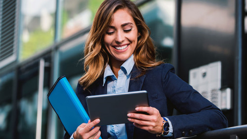 Young businesswoman working with tablet outdoor. Business, educa