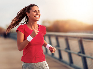 Beautiful woman running over bridge
