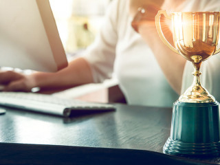 Business people working reward with golden trophy cup award to w