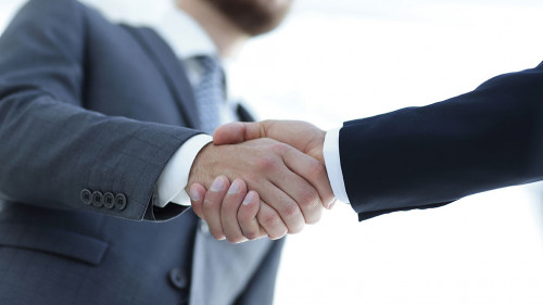 Successful business people handshaking after good deal.