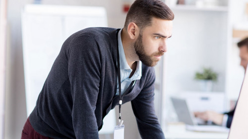Nervous Businessman using Computer