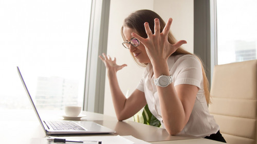 Angry businesswoman having problem with computer, broken laptop,