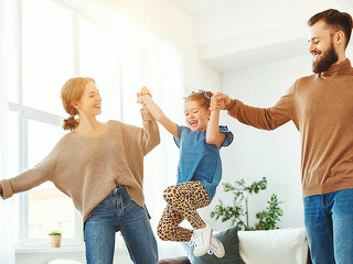 happy family mother father and child daughter dancing at home