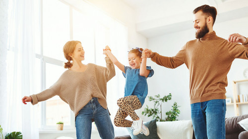 happy family mother father and child daughter dancing at home