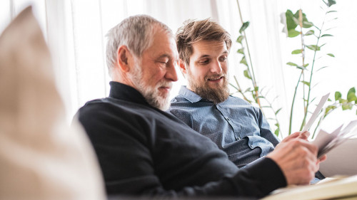 Hipster son and his senior father at home.
