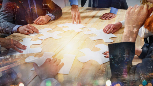 Teamwork of partners connect puzzle pieces as integration and startup