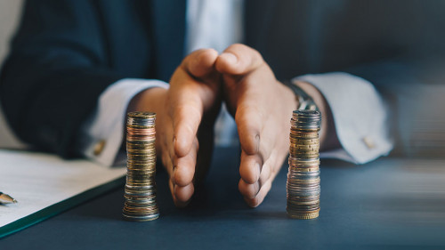 Businessman separates stack coins. Property division. Divorce an