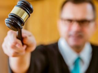 portrait judge man in courtroom holding judge gavel