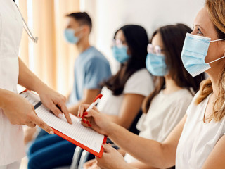 Health care and medical service. A woman signing up the form in