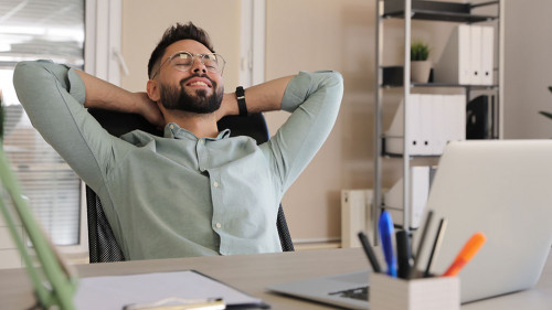 Businessman relaxing in office chair at workplace