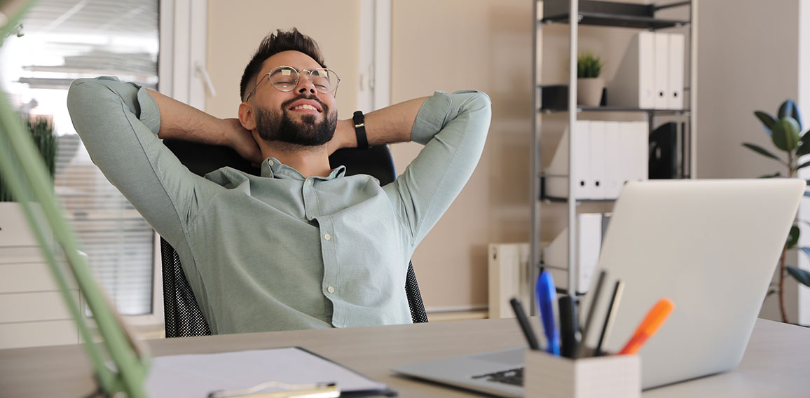Businessman relaxing in office chair at workplace